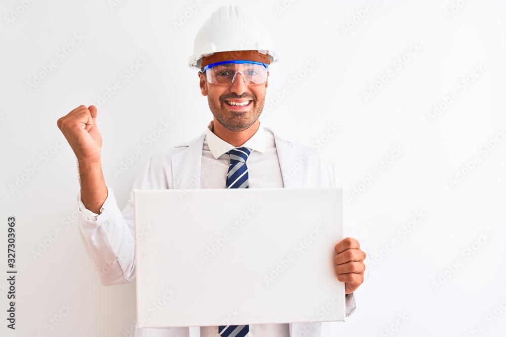 Young chemist man wearing security helmet holding signboard over isolated background screaming proud and celebrating victory and success very excited, cheering emotion Young chemist man wearing security helmet holding signboard over isolated background screaming proud and celebrating victory and success very excited, cheering emotion