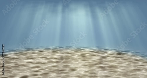 View of beautiful underwater scene. Sunlight from above water pass through the surface to sand floor. 