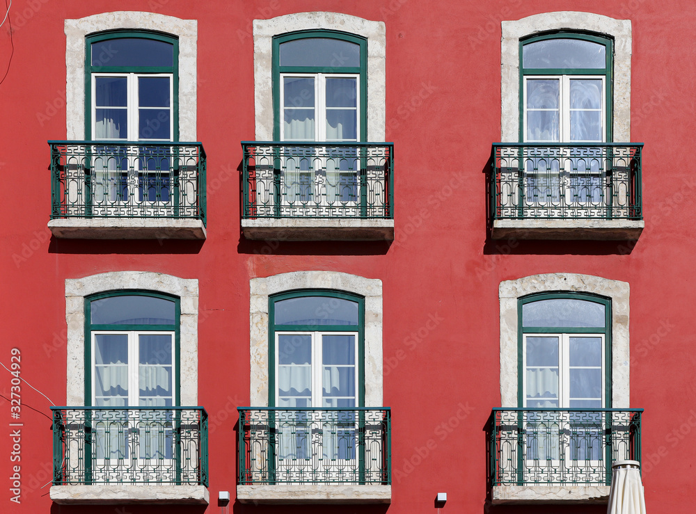 Element of the facade of the house. Old building with a red wall. Lisbon, Portugal.