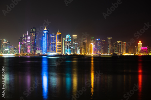 Vibrant Skyline of Doha at Night as seen from the opposite side of the capital city bay at night © Hladchenko Viktor