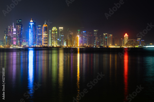 Vibrant Skyline of Doha at Night as seen from the opposite side of the capital city bay at night © Hladchenko Viktor