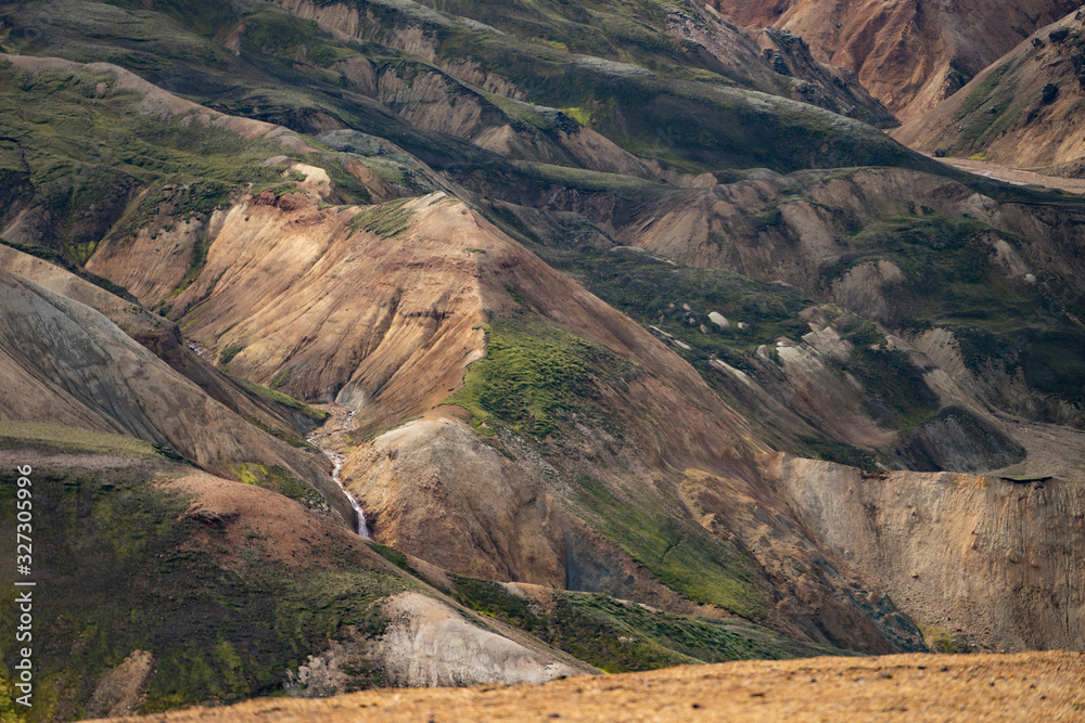 Landmannalaugar Colorful mountains on the Laugavegur hiking trail. Iceland. The combination of layers of multi-colored rocks, minerals, grass and moss