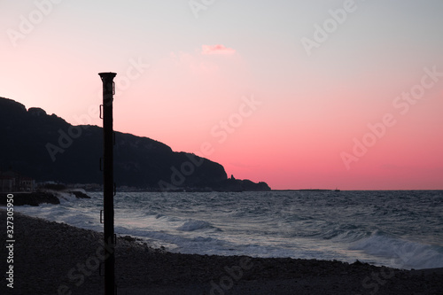 pink sunset overlooking the wavy sea