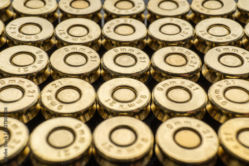 Close-up of a group of 9mm rounds. Cartridge background. New cartridges stacked neatly near each other. Close-up of a group of 9mm rounds. Cartridge background. New cartridges stacked neatly near each other.