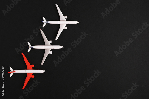 Three airplane models on a black background. place for inscription