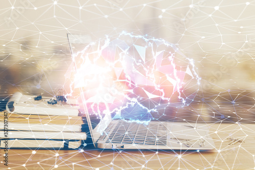 Multi exposure of work table with computer and brain hologram. Brainstorm concept.