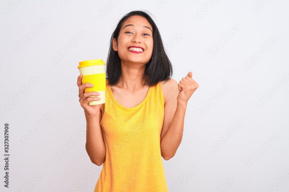 Young chinese woman drinking take away glass of coffee over isolated white background screaming proud and celebrating victory and success very excited, cheering emotion Young chinese woman drinking take away glass of coffee over isolated white background screaming proud and celebrating victory and success very excited, cheering emotion