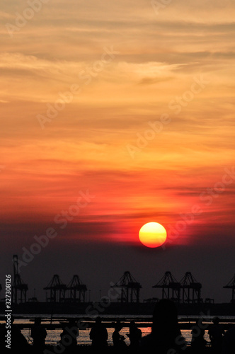 Photographer at the beach of beautiful sunset time