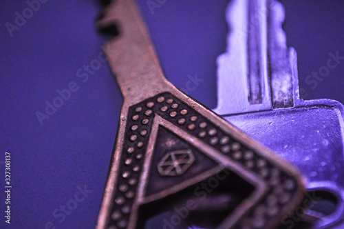 Close view of two door keys on blue blur background
