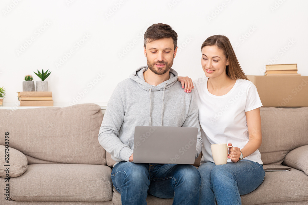Happy young couple buying furniture into new apartment Happy young couple buying furniture into new apartment