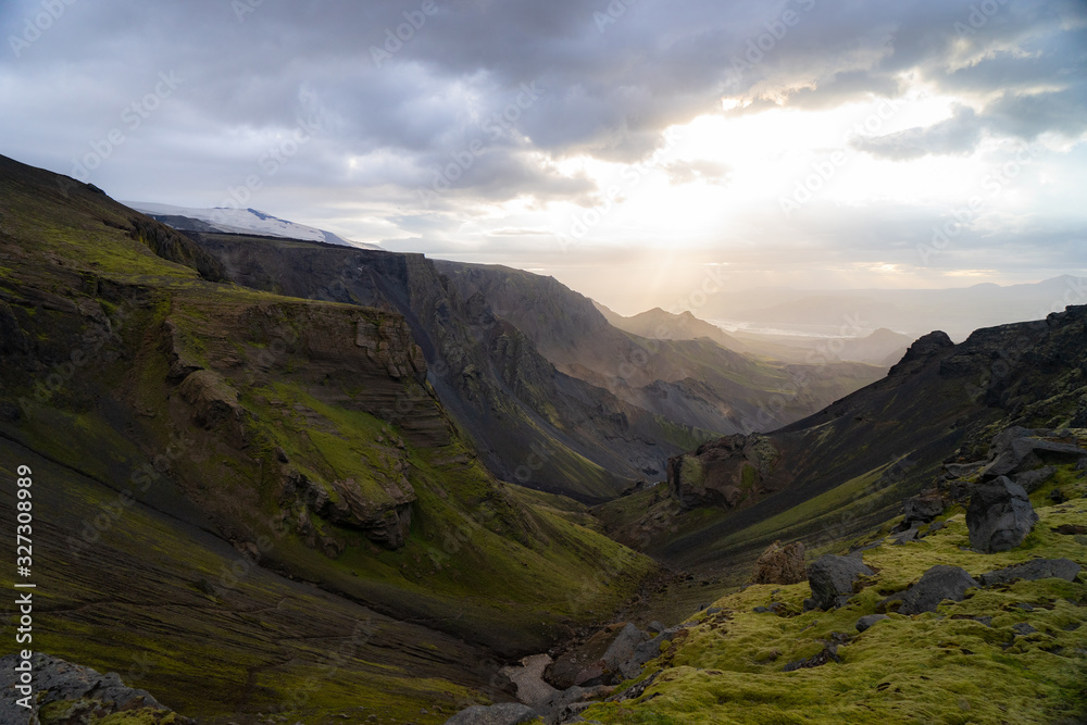 Fototapeta premium Canyon and Mountain peak during dramatic and colorful sunset on the Fimmvorduhals Hiking trail near Thorsmork