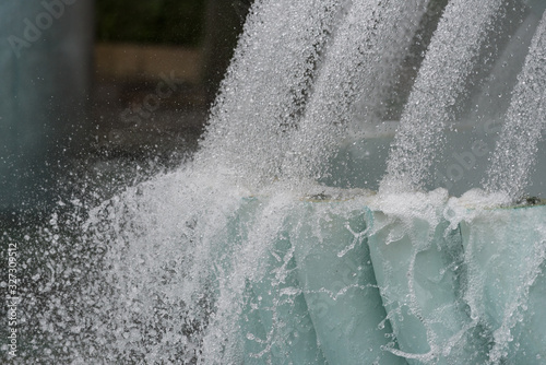 Water flowing in stream from tubes, pipes background photo