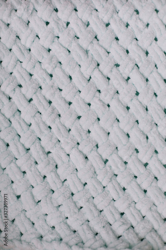Texture of knitted woolen fabric for wallpaper and an abstract background. Knitted texture background. Pattern of wool. 