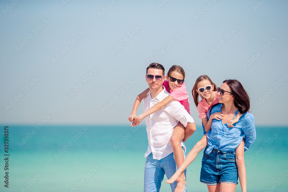 Happy family with kids on the beach together Happy family with kids on the beach together