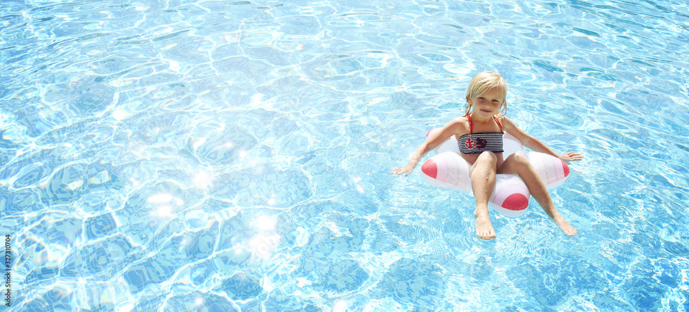 Little girl having fun time in the Swimming pool, Summer time, Vacation