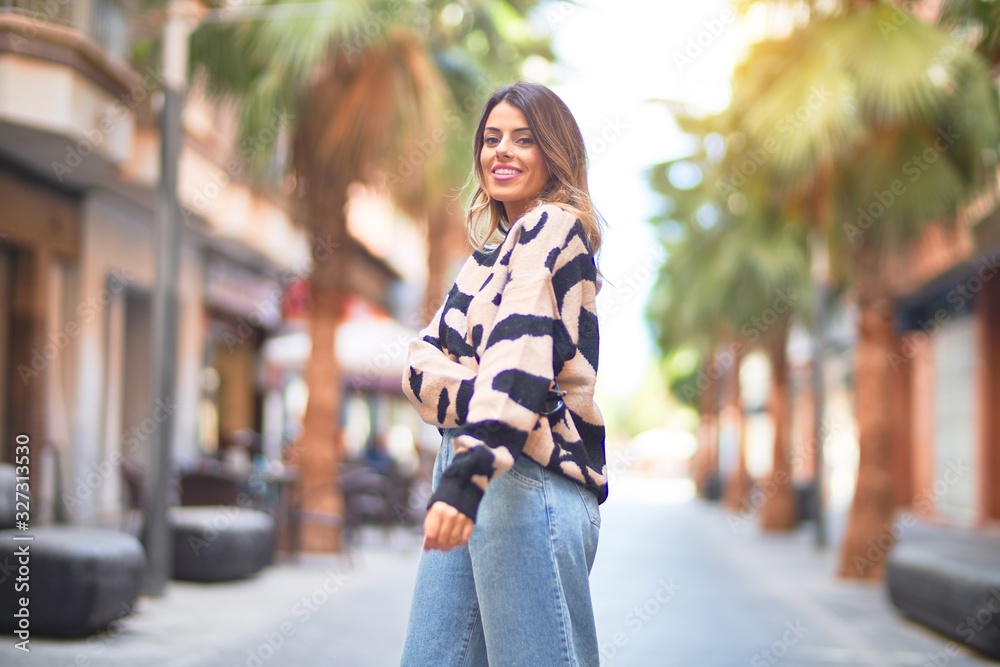 Young beautiful woman smiling happy and confident. Standing and walking at town street