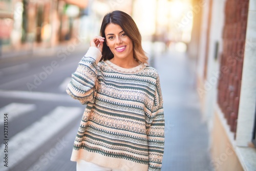 Young beautiful woman smiling happy and confident. Standing and walking at town street © Krakenimages.com