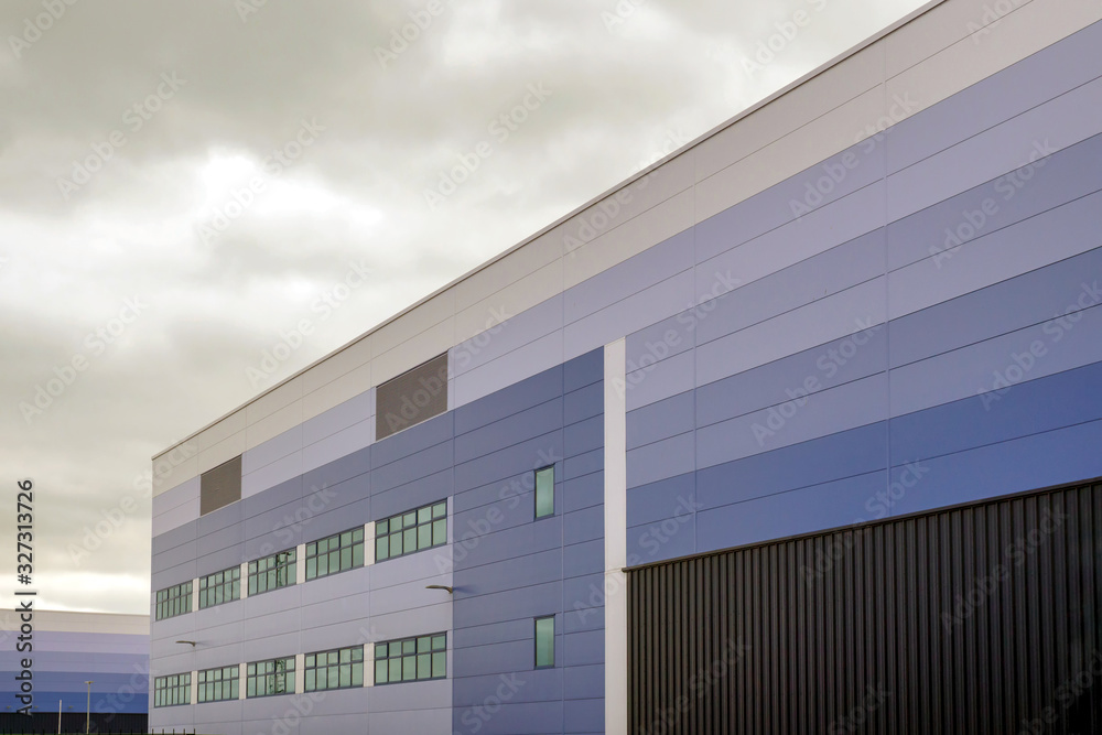 modern warehouse building over cloudy sky in england uk - obrazy, fototapety, plakaty 