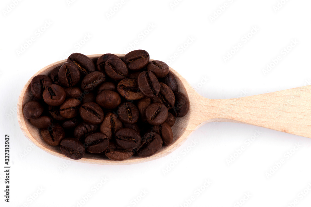 Fototapeta premium coffee beans in a spoon. tea in a spoon