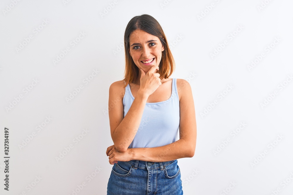 Beautiful redhead woman standing over isolated background looking confident at the camera smiling with crossed arms and hand raised on chin. Thinking positive. Beautiful redhead woman standing over isolated background looking confident at the camera smiling with crossed arms and hand raised on chin. Thinking positive.