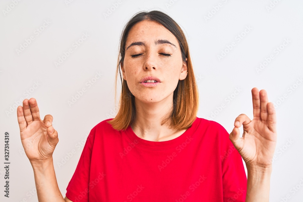 Beautiful redhead woman wearing casual red t-shirt over isolated background relax and smiling with eyes closed doing meditation gesture with fingers. Yoga concept. Beautiful redhead woman wearing casual red t-shirt over isolated background relax and smiling with eyes closed doing meditation gesture with fingers. Yoga concept.
