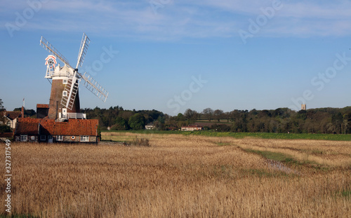 Landscape shot of a windmill and church tower, Norfolk England