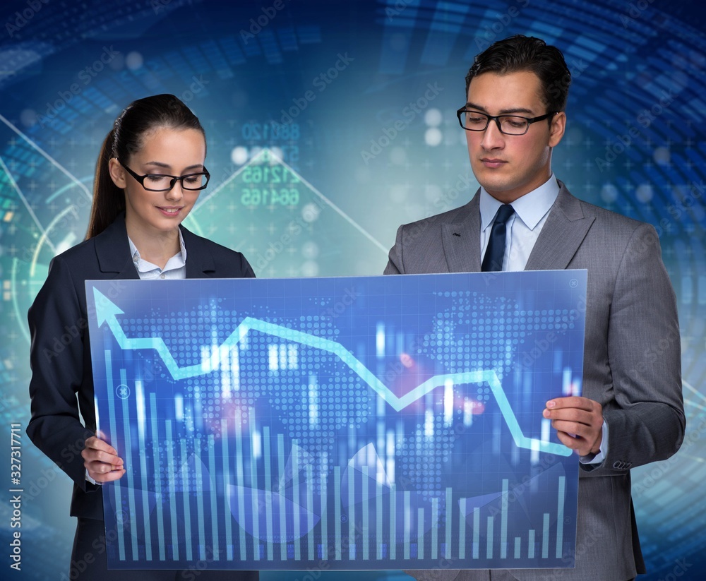 Business people discussing stock chart trends Business people discussing stock chart trends