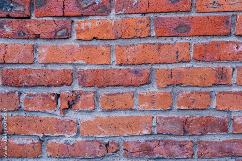 An old rusty red brick wall, typical of old European cities, is used for design solutions