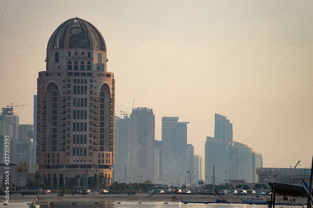 Naklejka premium Doha, Qatar, cityscape of modern but still oldschool buildings during sunset