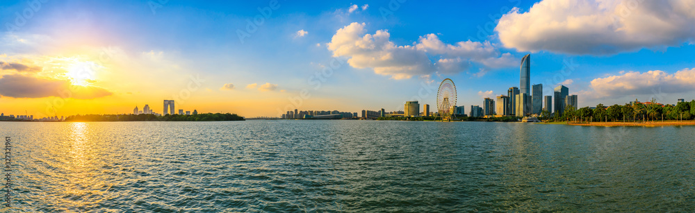 Beautiful city skyline and buildings with lake at sunset in Suzhou,panoramic view.