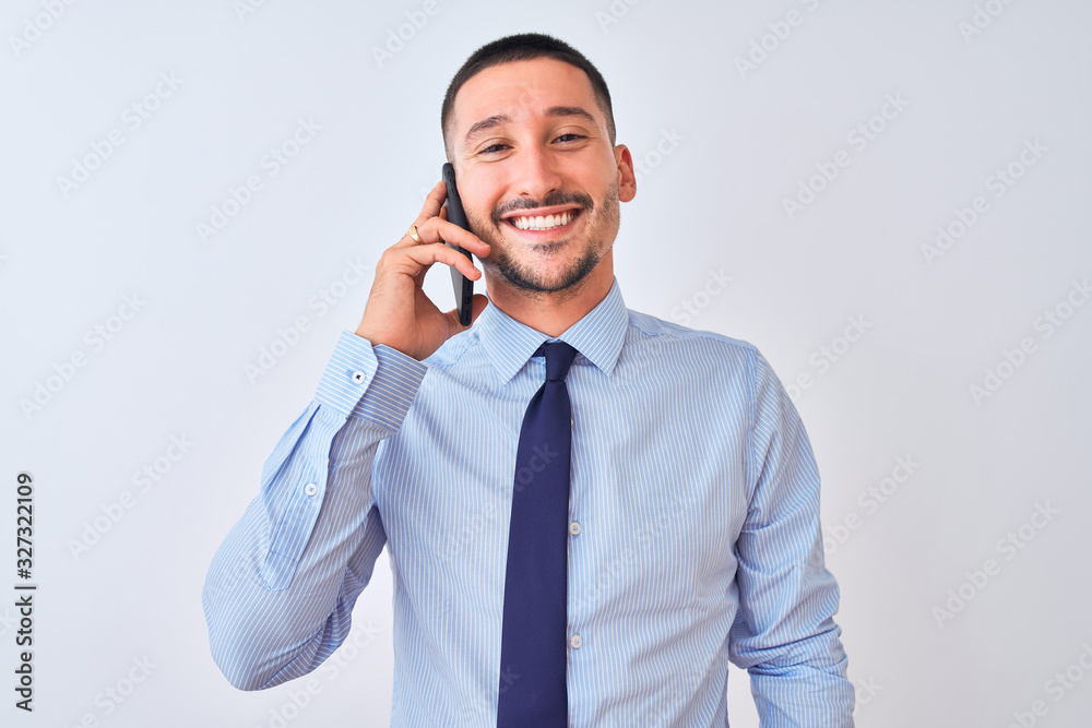 Young handsome business man calling using smartphone over isolated background with a happy face standing and smiling with a confident smile showing teeth Young handsome business man calling using smartphone over isolated background with a happy face standing and smiling with a confident smile showing teeth