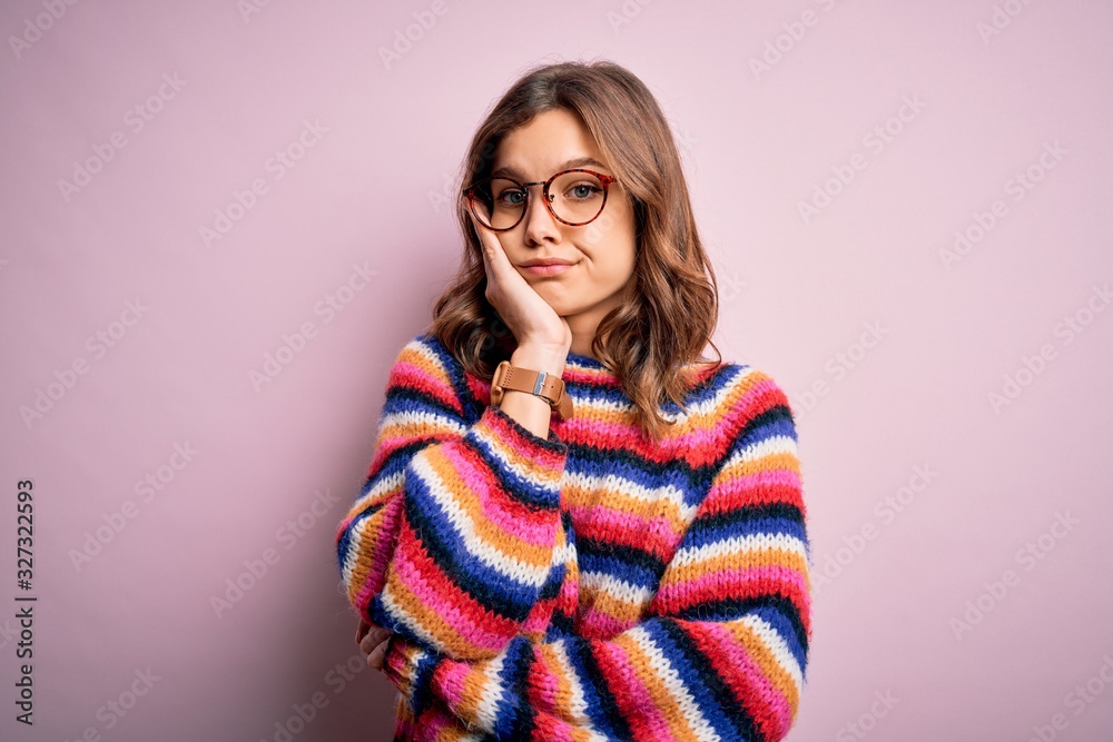 Young beautiful blonde girl wearing glasses and casual sweater over pink isolated background thinking looking tired and bored with depression problems with crossed arms. Young beautiful blonde girl wearing glasses and casual sweater over pink isolated background thinking looking tired and bored with depression problems with crossed arms.