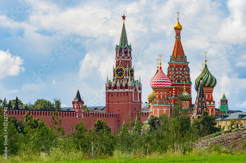 Moscow. Russia. View of the Moscow Kremlin from the hill. Spasskaya tower of the Kremlin and St. Basil's Cathedral against the sky. Symbol of statehood and religious symbol of Russia.