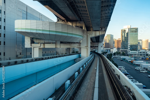 Japan. Transport system of the Japanese capital. Railway urban transport. Multi-level transport bridges in Tokyo. Parking for cars and transport paths on the background of buildings. © Grispb