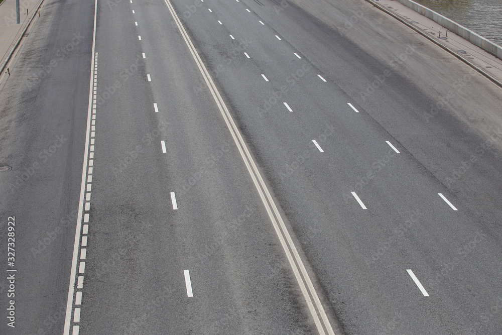 Multi-lane highway with markings on asphalt Multi-lane highway with markings on asphalt