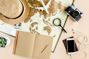 Planning vacation, travel plan, trip vacation using world map along with other travel accessories. Top view, flat lay. Travel, vacation concept.