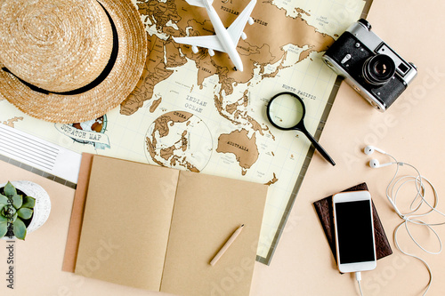 Planning vacation, travel plan, trip vacation using world map along with other travel accessories. Top view, flat lay. Travel, vacation concept.