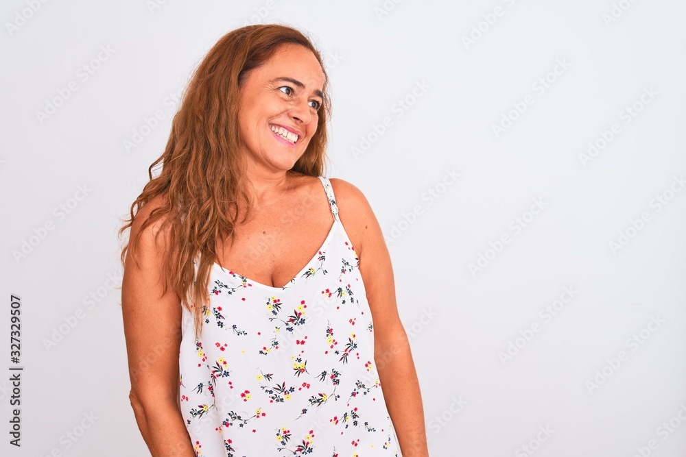 Middle age mature woman standing over white isolated background looking away to side with smile on face, natural expression. Laughing confident. Middle age mature woman standing over white isolated background looking away to side with smile on face, natural expression. Laughing confident.