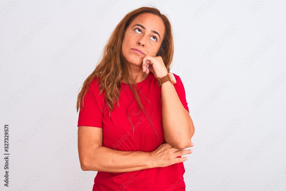 Middle age mature woman standing over white isolated background with hand on chin thinking about question, pensive expression. Smiling with thoughtful face. Doubt concept. Middle age mature woman standing over white isolated background with hand on chin thinking about question, pensive expression. Smiling with thoughtful face. Doubt concept.