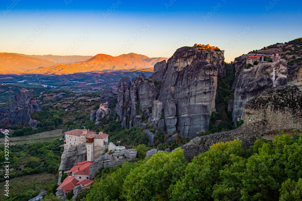 Greece. Meteora at sunset. Monasteries on the rocks in Greece. World-famous sights of Greece. The mountainous landscape and monasteries on mountain tops. The stunning landscape of Meteora.