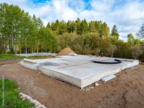 Construction of a country house. The concrete Foundation of the cottage on the lake shore is filled in. Work on the construction of a new house. Foundation for the cottage. © Grispb