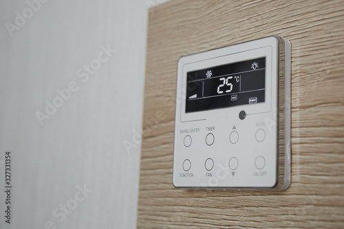 air conditioner screen on the wall that shows an air temperature of 25 degrees Celsius