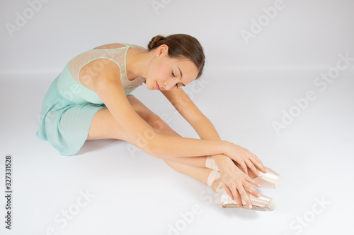 Young beautiful girl warming up for ballet
