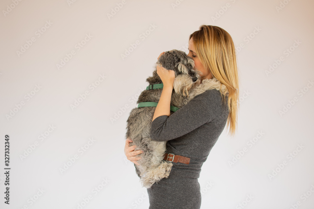 Young beautiful girl with dog in her arms