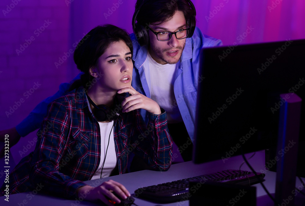 Millennial Couple Playing Computer Games Sitting Together At Home Millennial Couple Playing Computer Games Sitting Together At Home