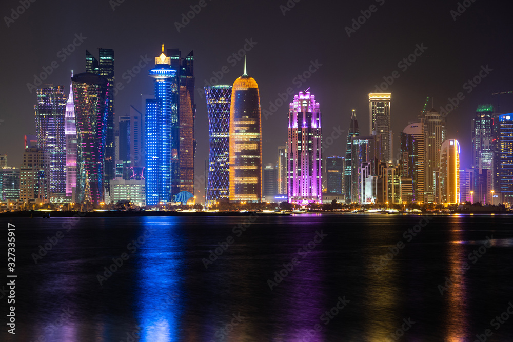 Fototapeta premium Vibrant Skyline of Doha at Night as seen from the opposite side of the capital city bay at night