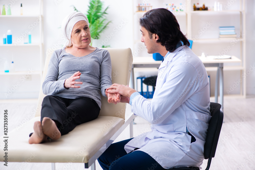 Young male doctor and female oncology patient