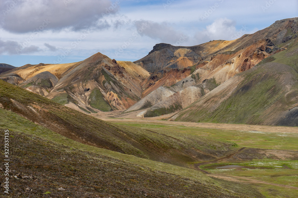Landmannalaugar Colorful mountains on the Laugavegur hiking trail. Iceland. The combination of layers of multi-colored rocks, minerals, grass and moss Landmannalaugar Colorful mountains on the Laugavegur hiking trail. Iceland. The combination of layers of multi-colored rocks, minerals, grass and moss