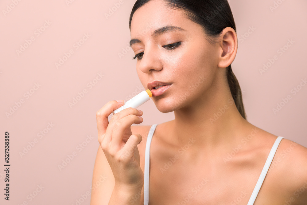 beautiful young woman using lipstick to moisturize her lips. natural lips and protective lipstick beautiful young woman using lipstick to moisturize her lips. natural lips and protective lipstick