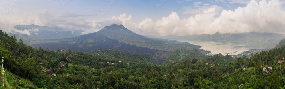 Wide panorama of Mount Batur or Gunung Batur, an active volcano located at the center of caldera and Mount Agung which dominates the surrounding area on the island of Bali, Indonesia